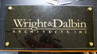 Wright and Dalbin Architects logo etched into polished granite
