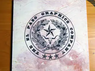 El Paso Graphics Company logo etched into marble with black color fill